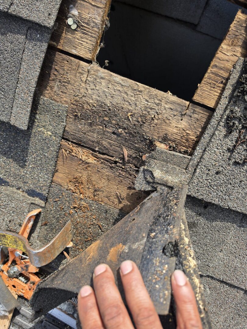 Rotten roof decking exposed during repair